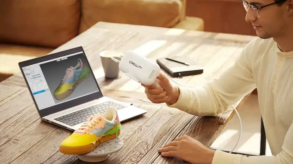 Scanning a sneaker in front of a laptop