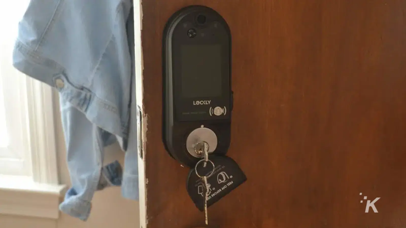 Lockly Vision Elite door lock on wooden door with the keys in the lock.