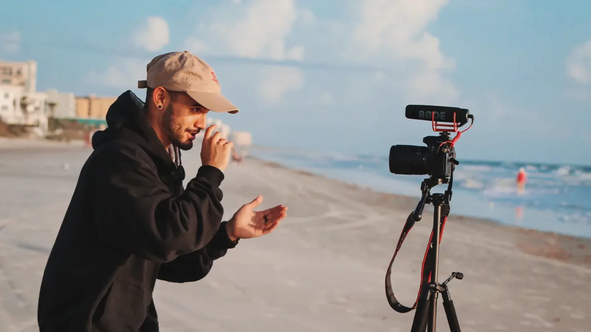 Person recording himself with a camera on the beach