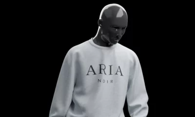 Aria Noir model wearing white sweater