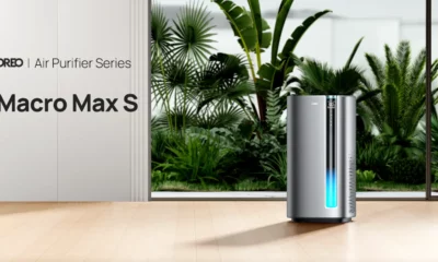 Dreo Air Purifier Macro Max S on a wooden floor with a door behind it with plants