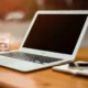 laptop with privacy screen on a wooden desk.