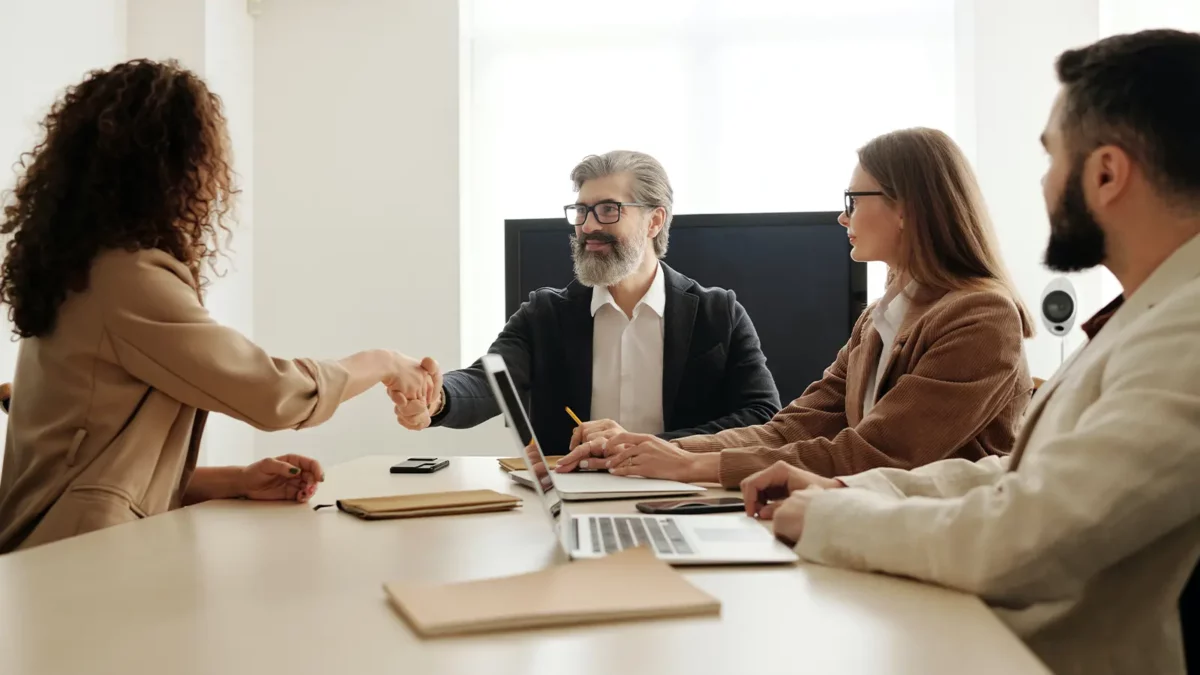 Hiring laravel developers in a meeting shaking hands