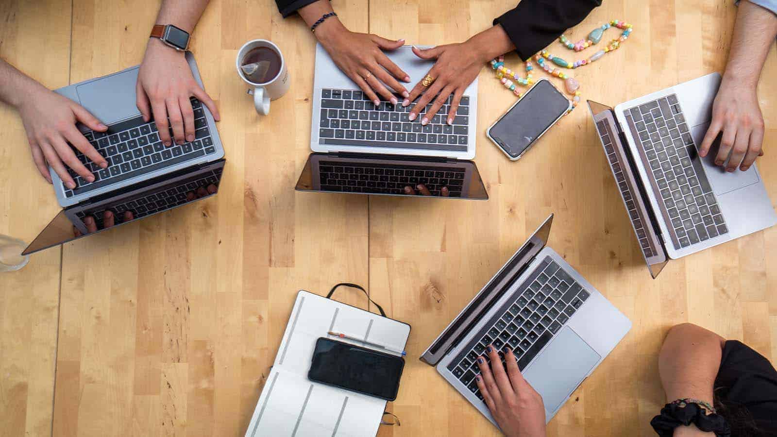 group of people with laptops