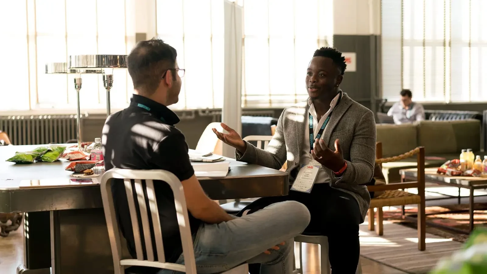 two people sitting down talking to each other. Communication