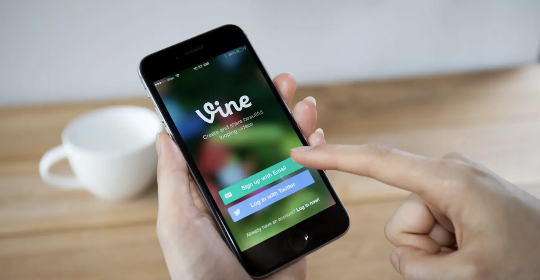 person holding phone with the vine app displayed