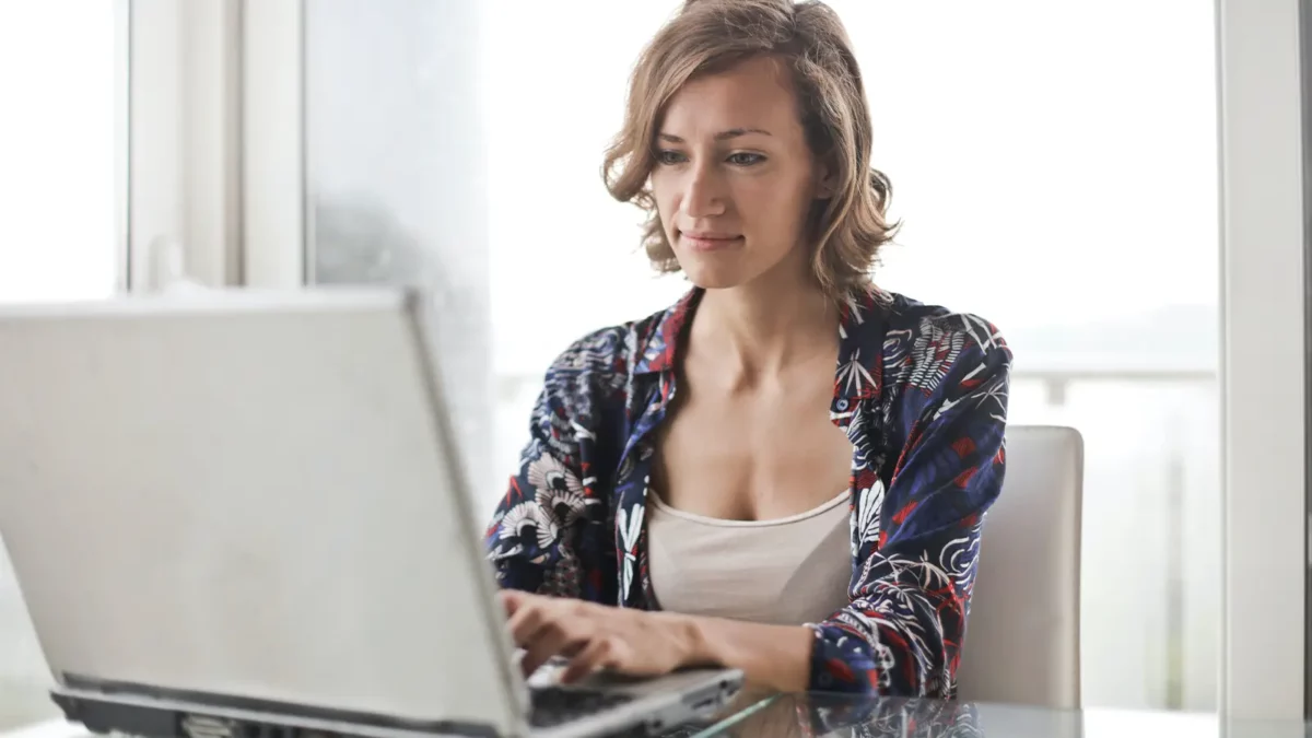 woman on computer in white room