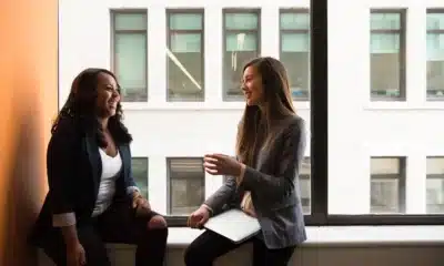 women chatting by a window