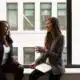 women chatting by a window