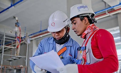 Construction workers looking at a piece of paper