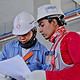 Construction workers looking at a piece of paper