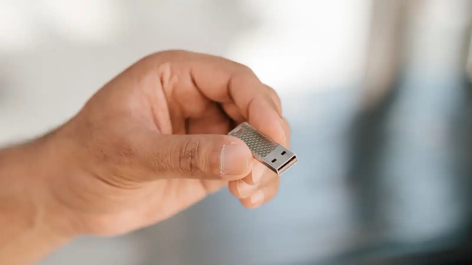 Hand holding a USB drive 