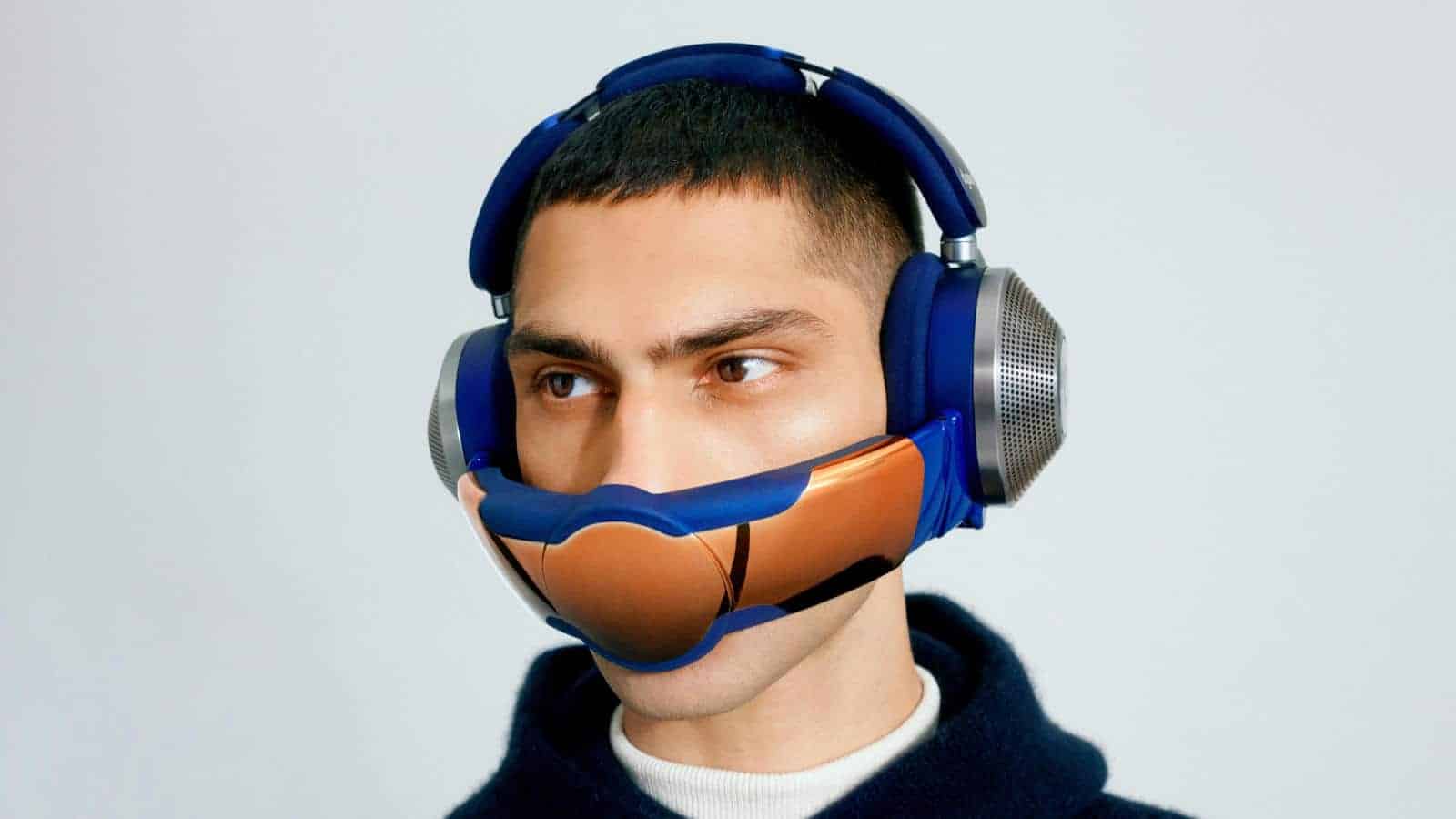 a user wearing the dyson zone headphones with the filtration visor attached against a light background