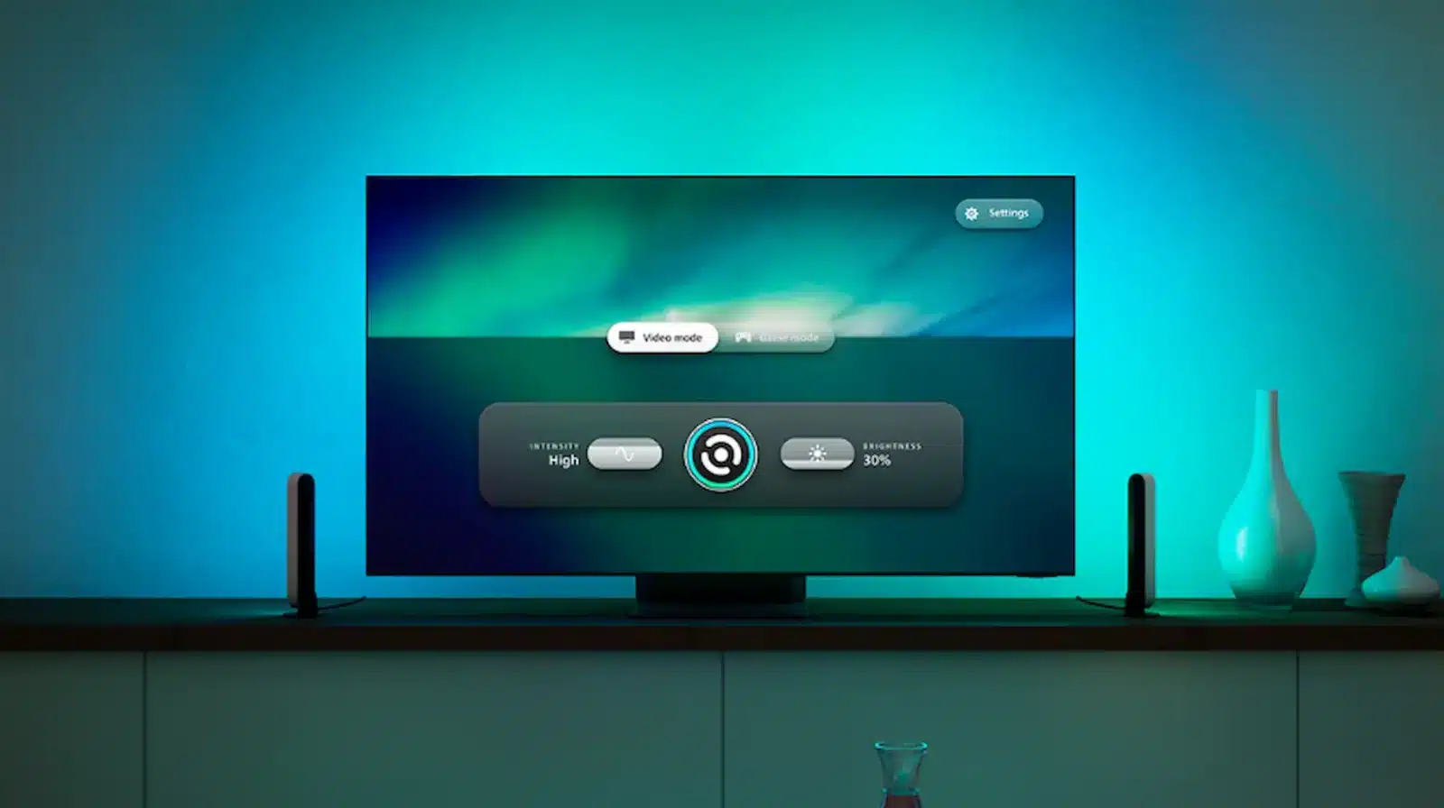 Philips hue new sync tv app on a samsung tv with glowing blue lights behind it