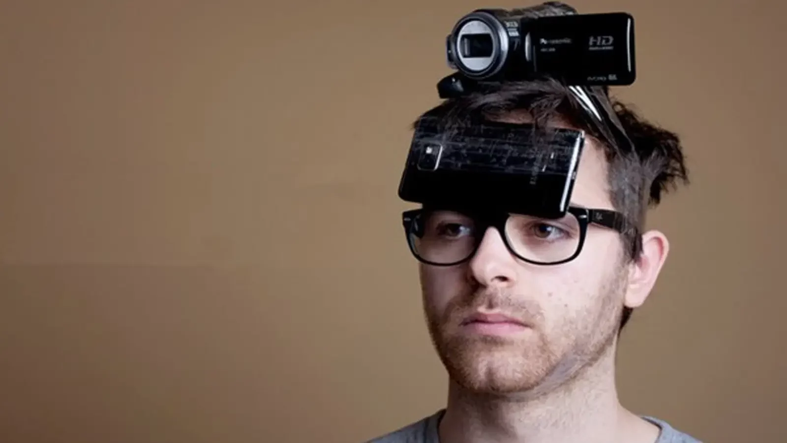 person wearing camera and smartphone on head