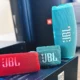 JBL portable speakers, three of them on a box