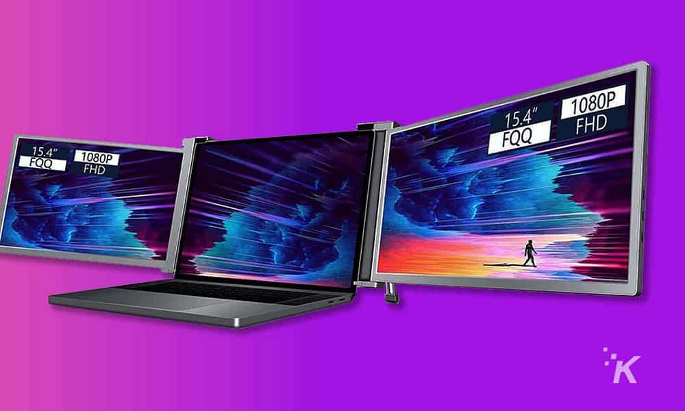 dual monitors with a laptop on purple background