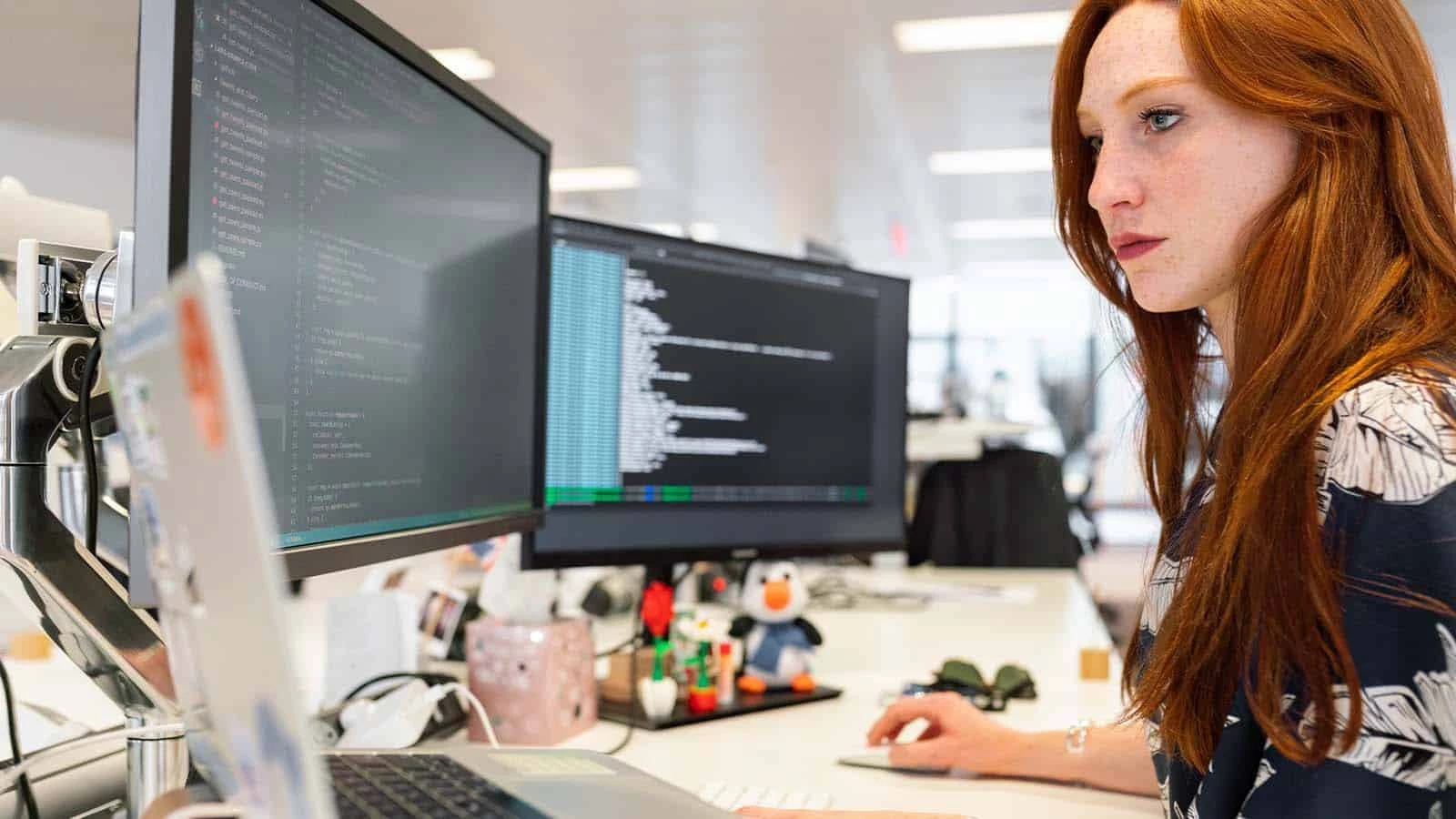 woman looking at computer screen at tech job