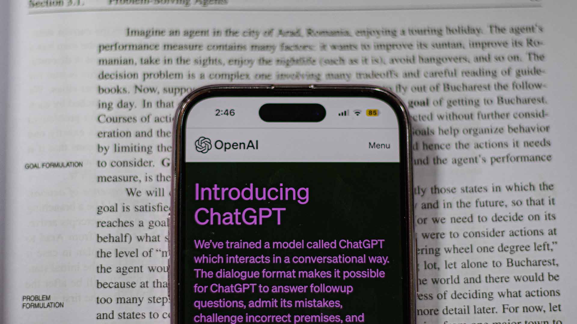 ChatGPT on phone in front of text