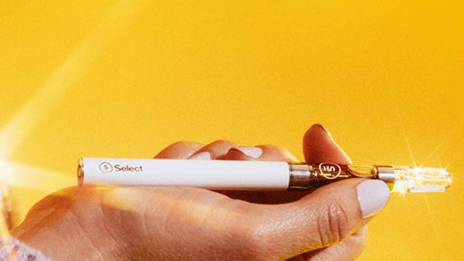 A person holds a Select original vape cart