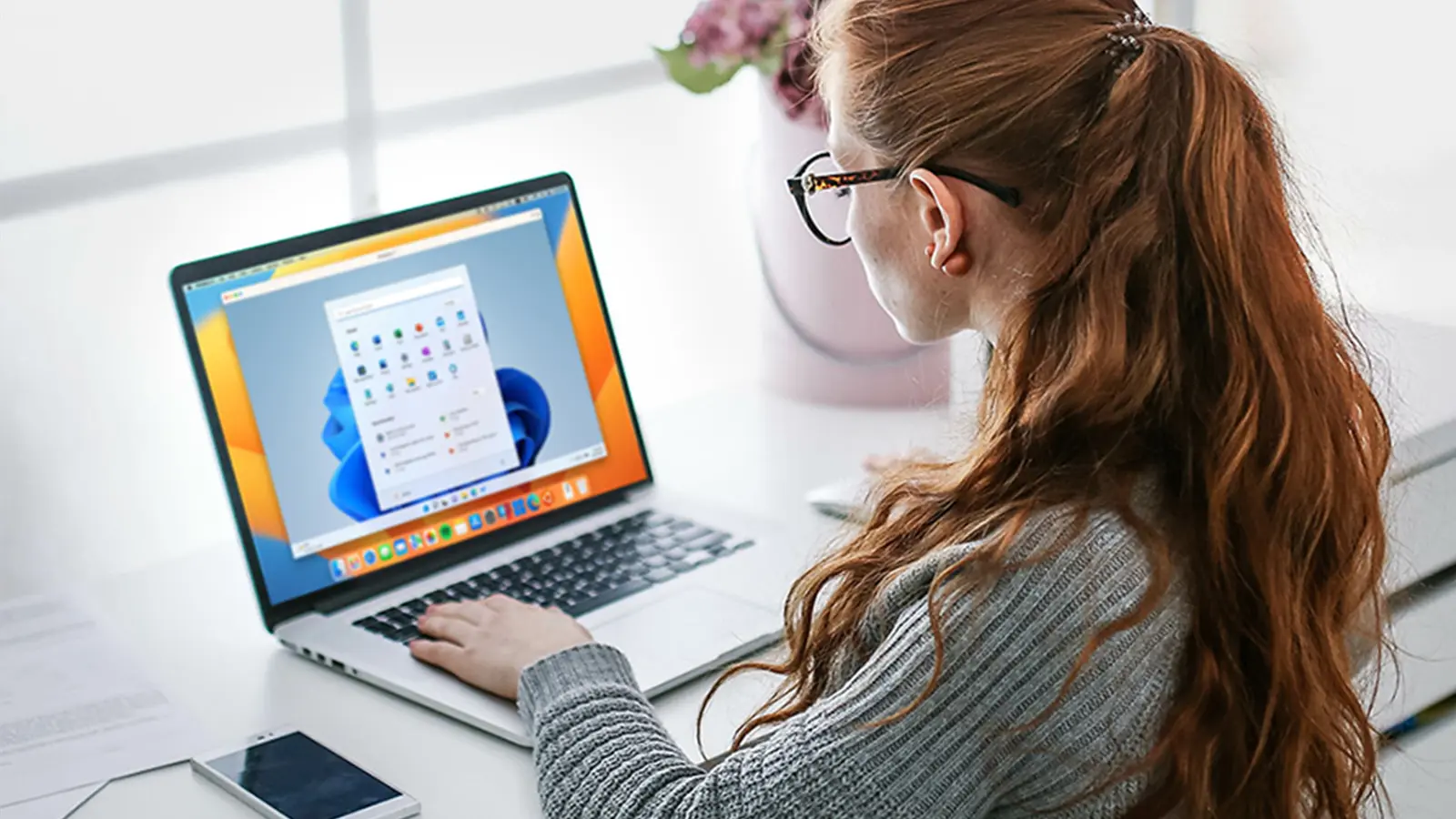 Woman typing on macbook laptop using windows os