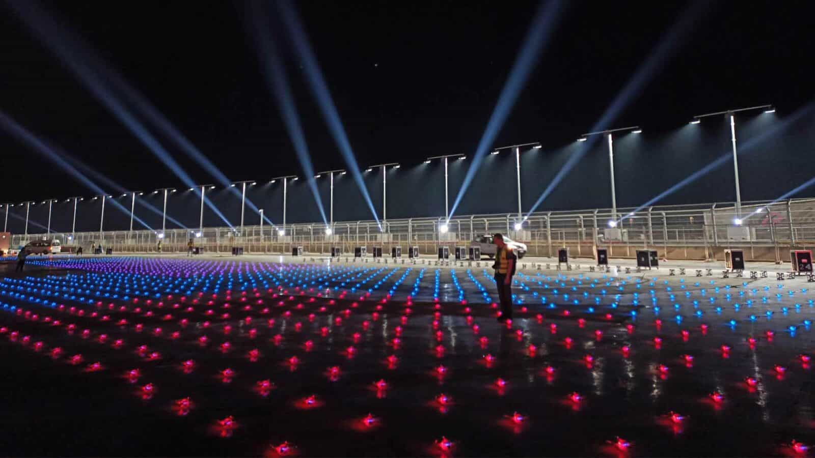 The outdoor arena is illuminated by the bright lights of the night concert.