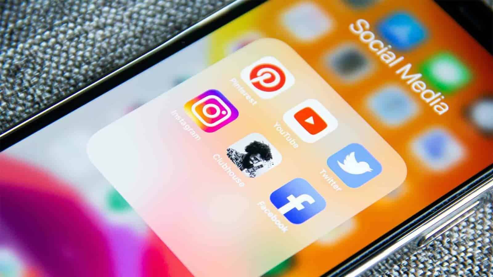 The camera focuses on a cell phone. Social media apps