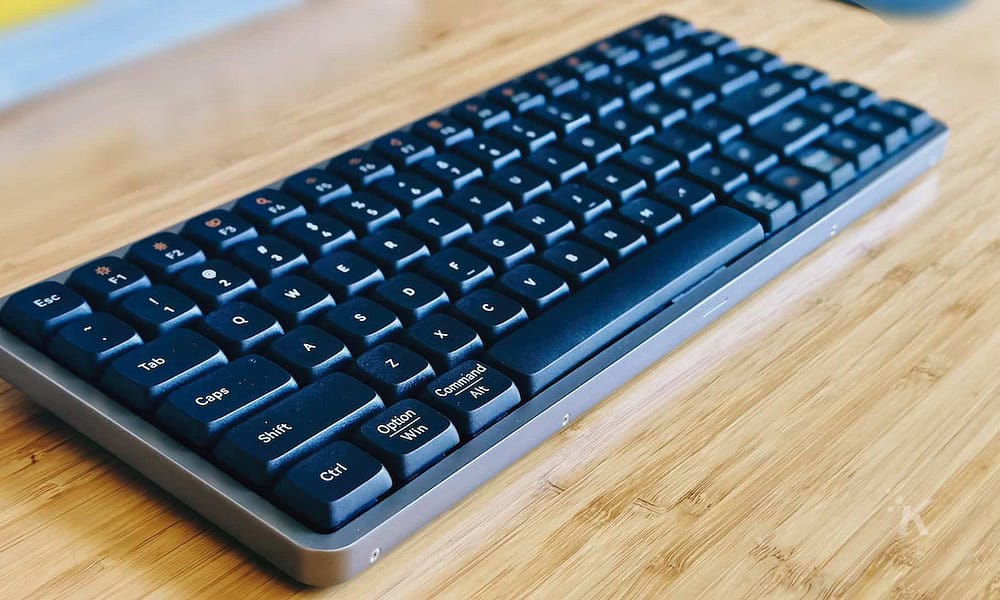 A lowfree flow mechanical keyboard sits on the table.