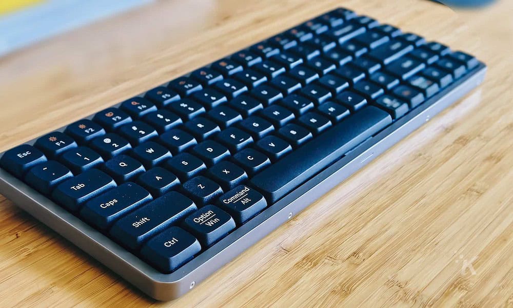 A lowfree flow mechanical keyboard sits on the table.