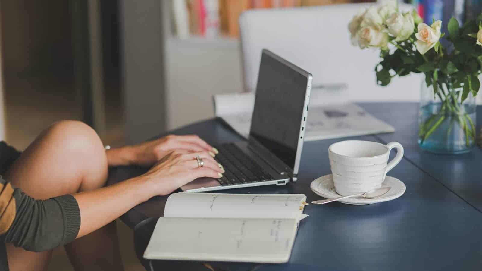 A person is using a laptop on a desk