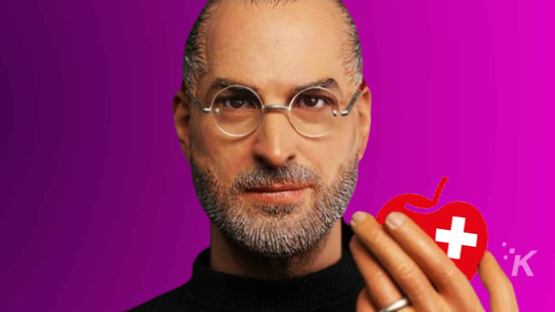 Steve Jobs holds a red apple logo