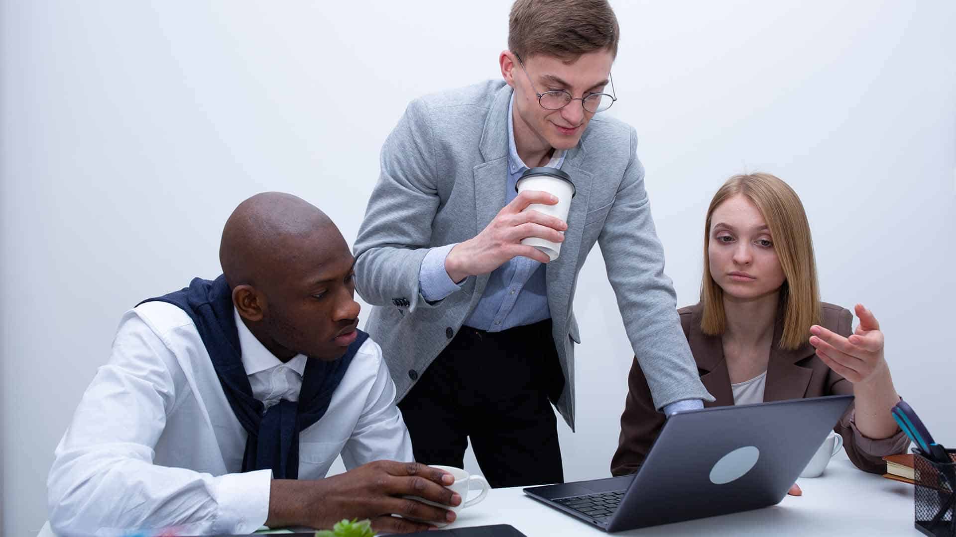 A group is viewing a laptop.