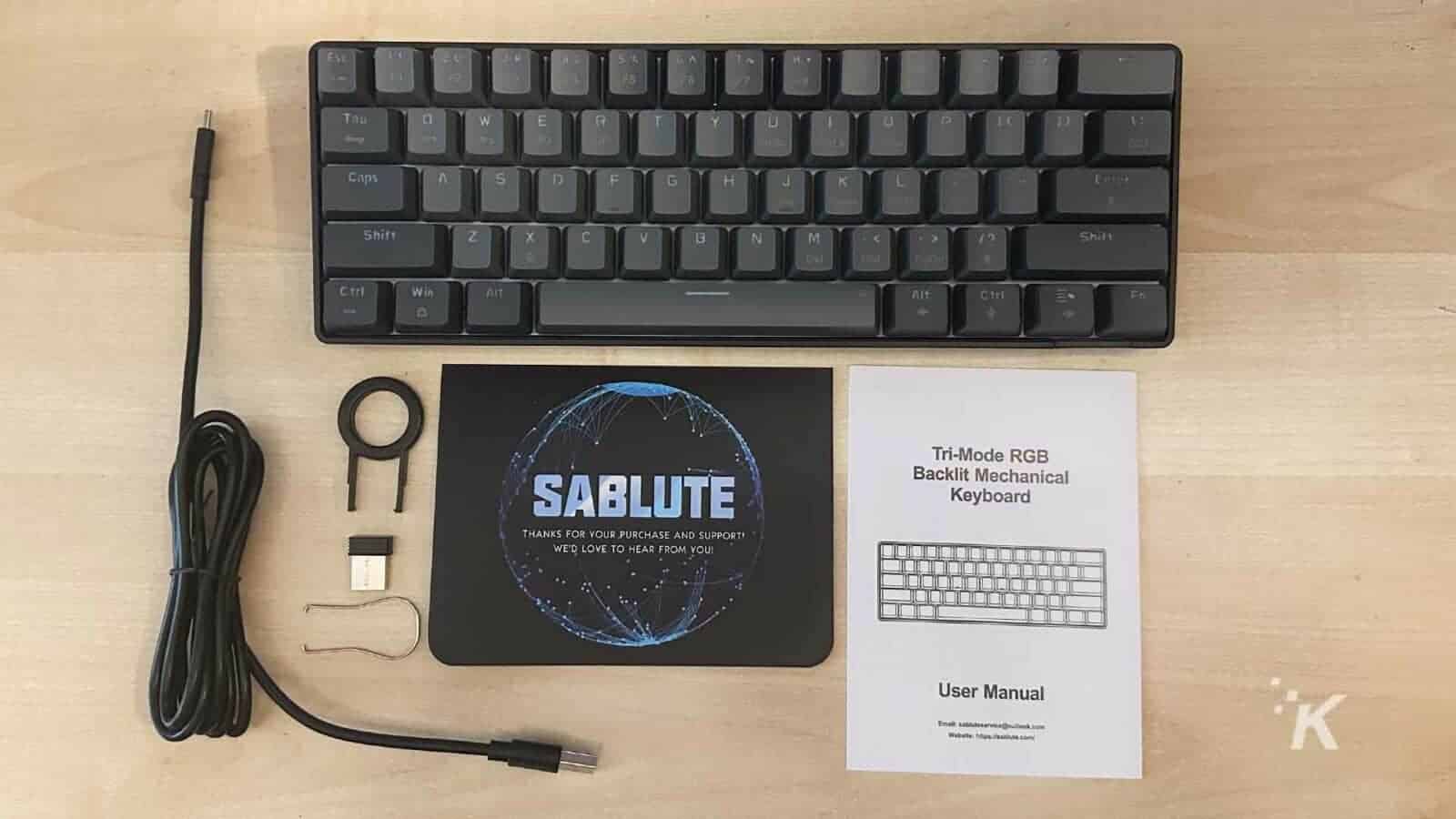 The user has just purchased a tri-mode RGB SABLUTE backlit mechanical keyboard and is being thanked for their purchase and support. Full Text: Est H F2 71 F5 - Tab W E R T Y U RF Caps A S H K L Enlet Shift Z X C V IN M Shift Ctrl Win Alt Alt Ctrl C Tri-Mode RGB SABLUTE Backlit Mechanical Keyboard THANKS FOR YOUR PURCHASE AND SUPPORT! WE'D LOVE TO HEAR FROM YOU! User Manual K Email: sabluteservice@outlook.com Weballa: https:/isablute.com/