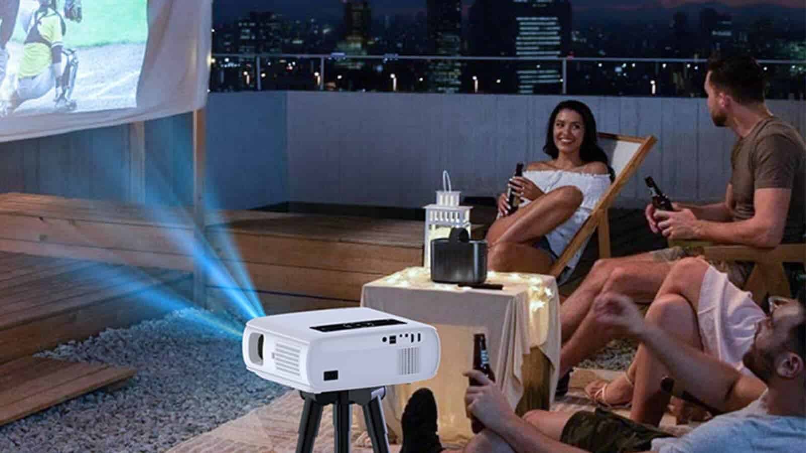 A person and a person are sitting in an indoor setting, watching a GROVIEW projector display on a human face.