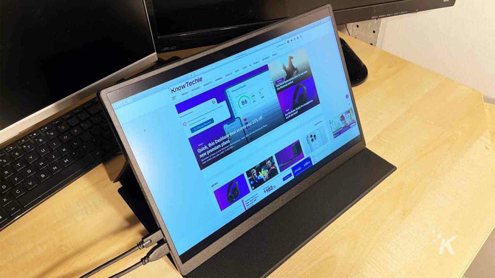 UPERFECT-portable-monitor on a desk with the KnowTechie website on screen