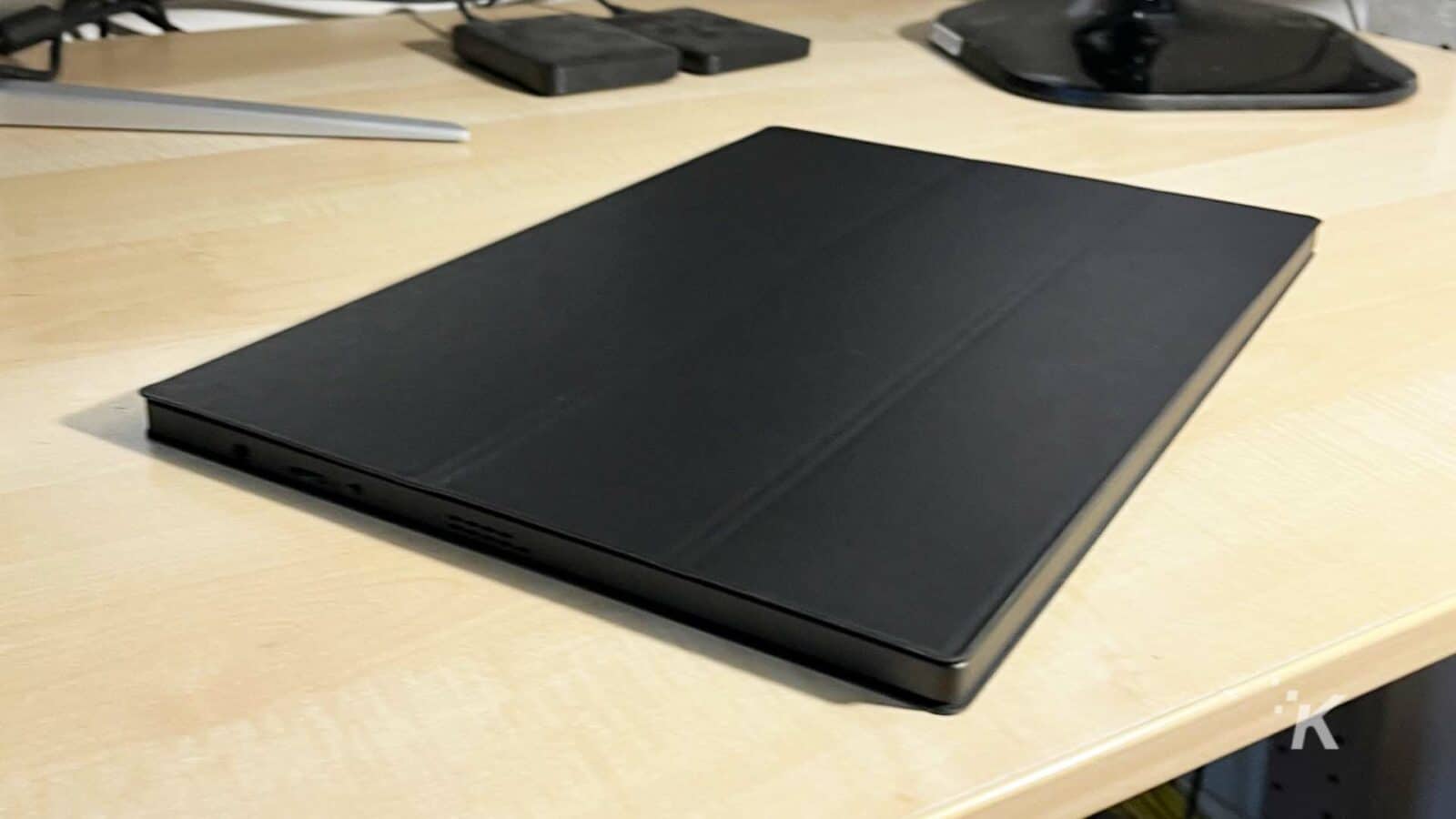 UPERFECT-portable-monitor on a desk with the cover on.