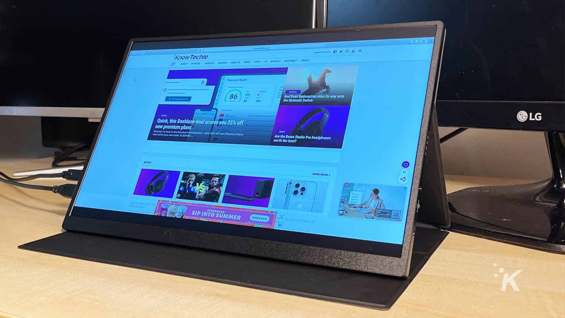 UPERFECT-portable-monitor on a desk with the KnowTechie website on screen