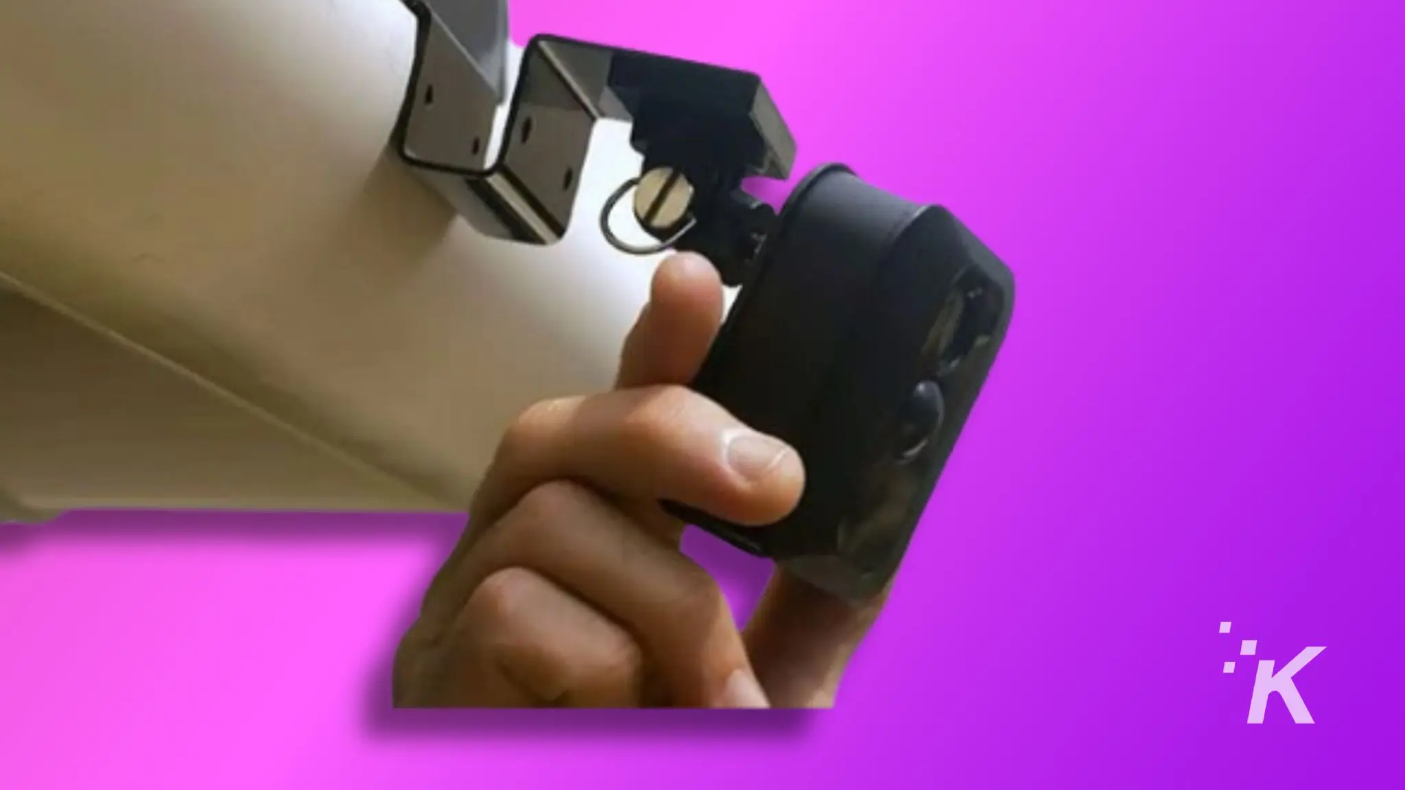 A person is holding a blink camera