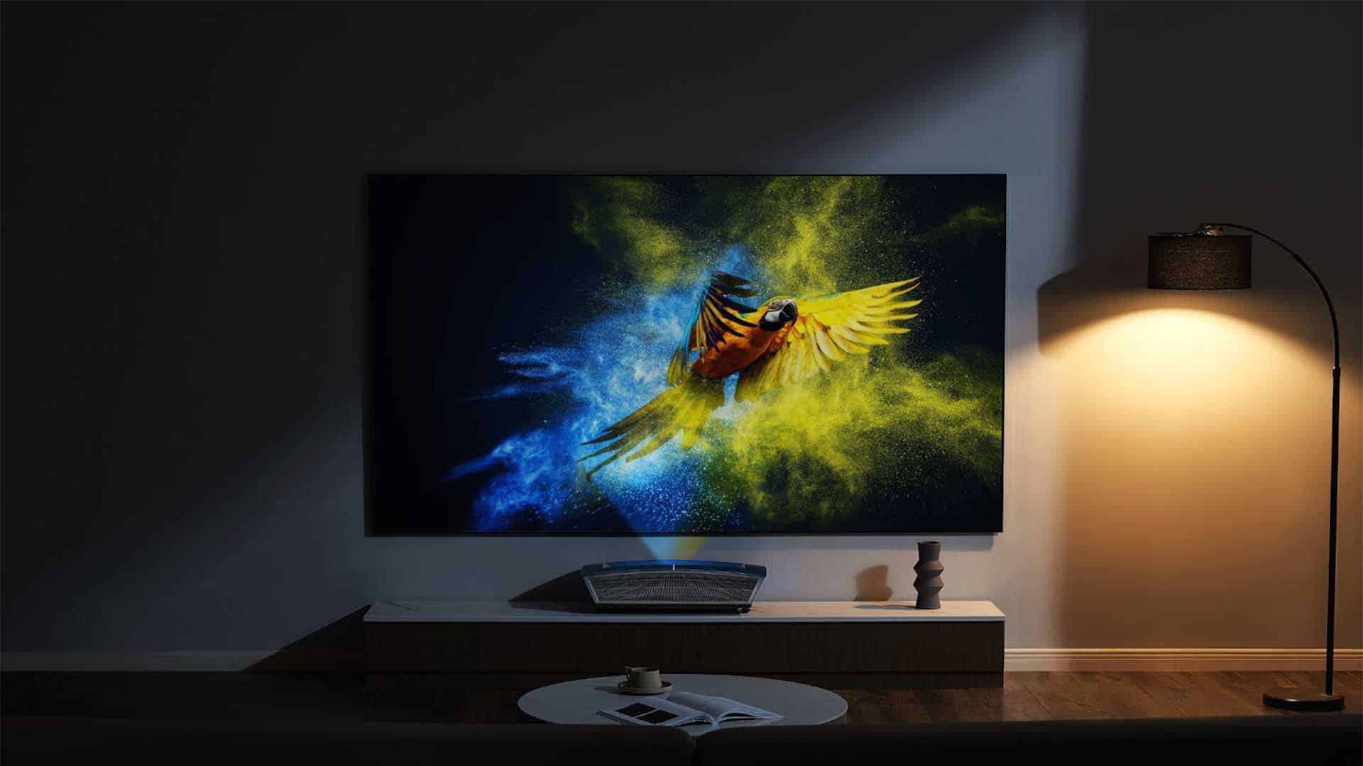 A lamp illuminates a painting in a picture frame, while a flat panel display and television provide additional art and light in the indoor space.