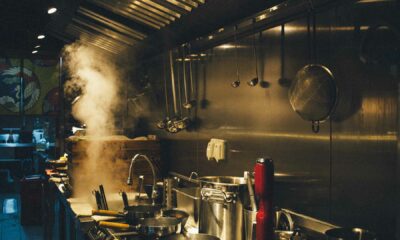 A steel locomotive is cooking in the night-lit kitchen of a factory.