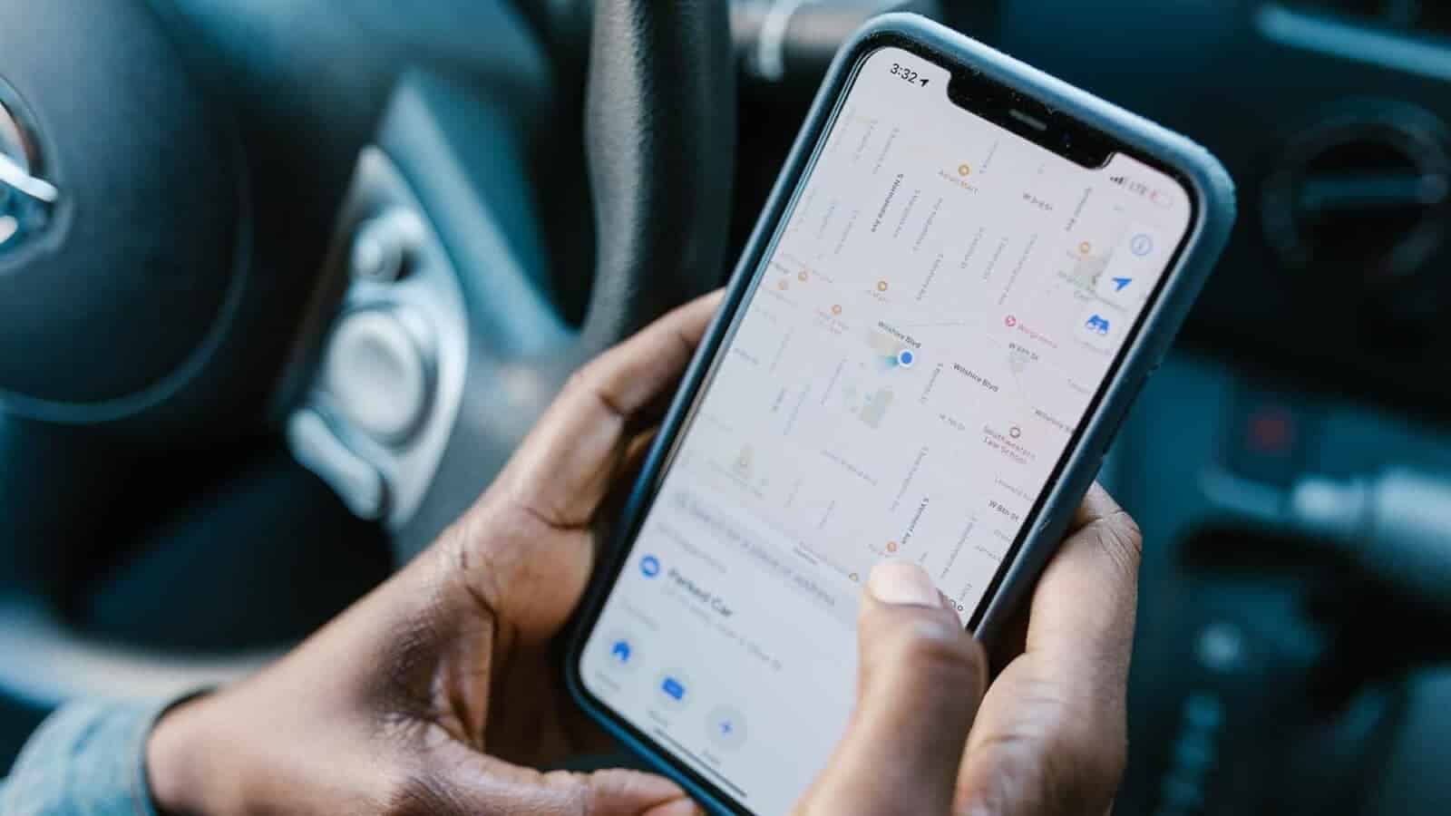 A person holds phone looking at their GPS maps.