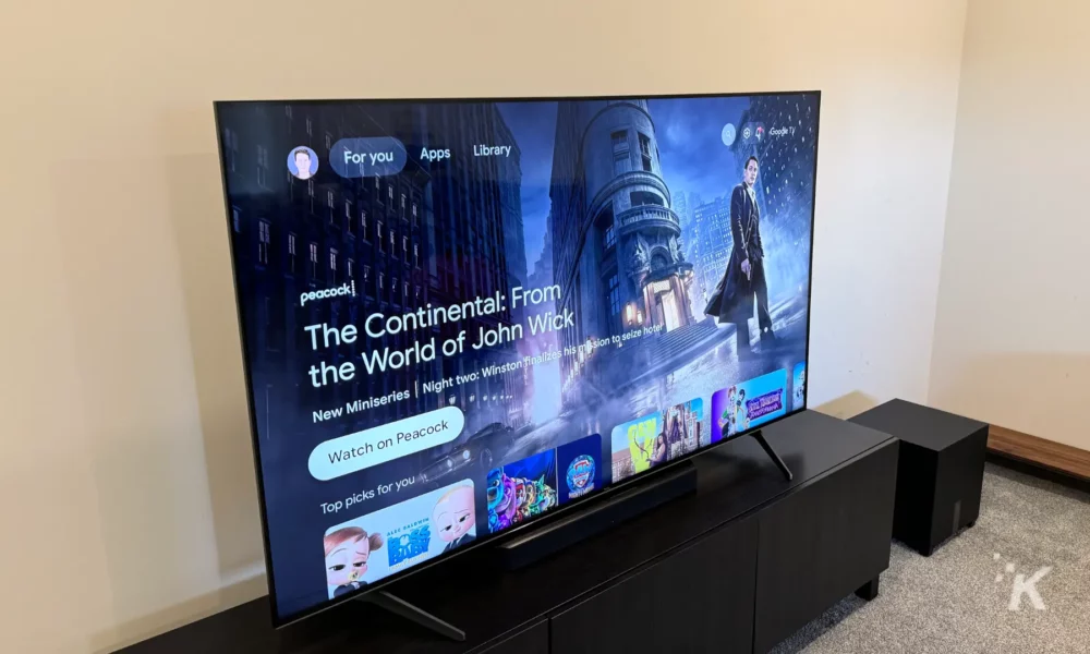Tcl q7 65-inch qled tv on a cabinet