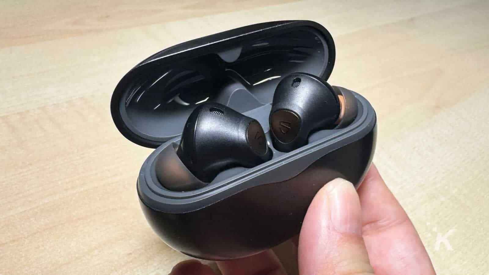 Soundpeats air4 pro earbuds with case in hand