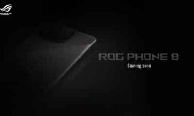 A dark promotional image featuring a smartphone with the text "ROG PHONE 8" and "Coming soon." The device logo glows, hinting at gaming features.