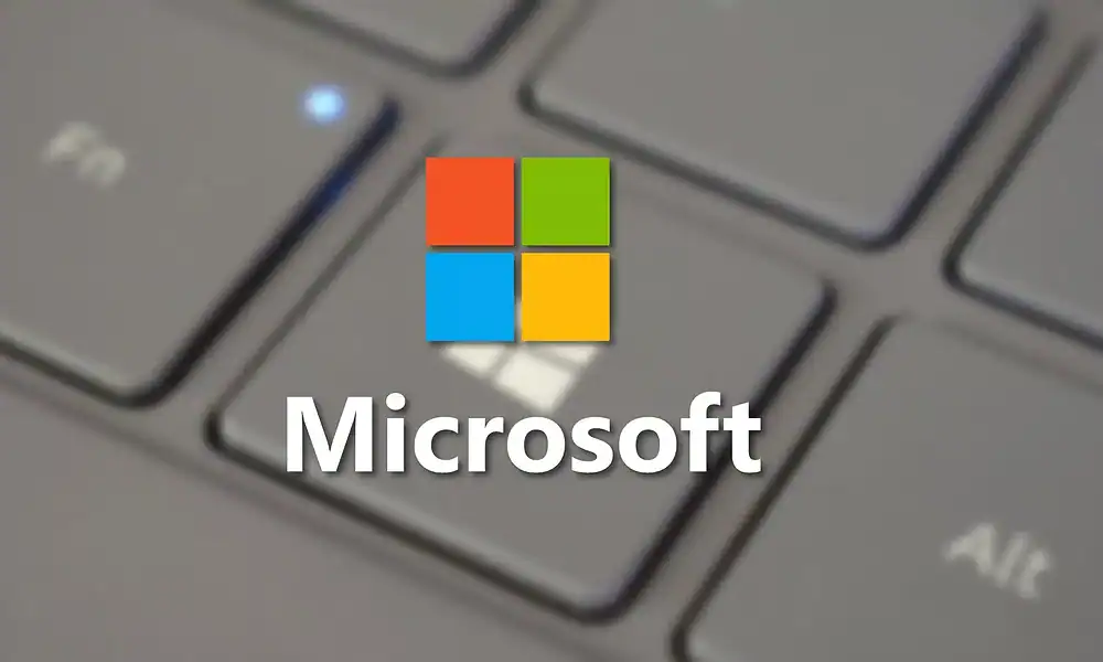 A close-up of a laptop keyboard with a Microsoft logo superimposed in the center on a semi-transparent background.