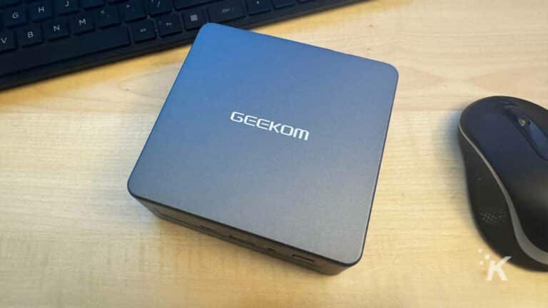 GEEKOM Mini IT11 PC on desk with a keyboard and mouse