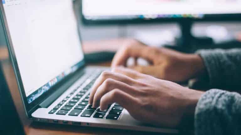 person typing on a laptop