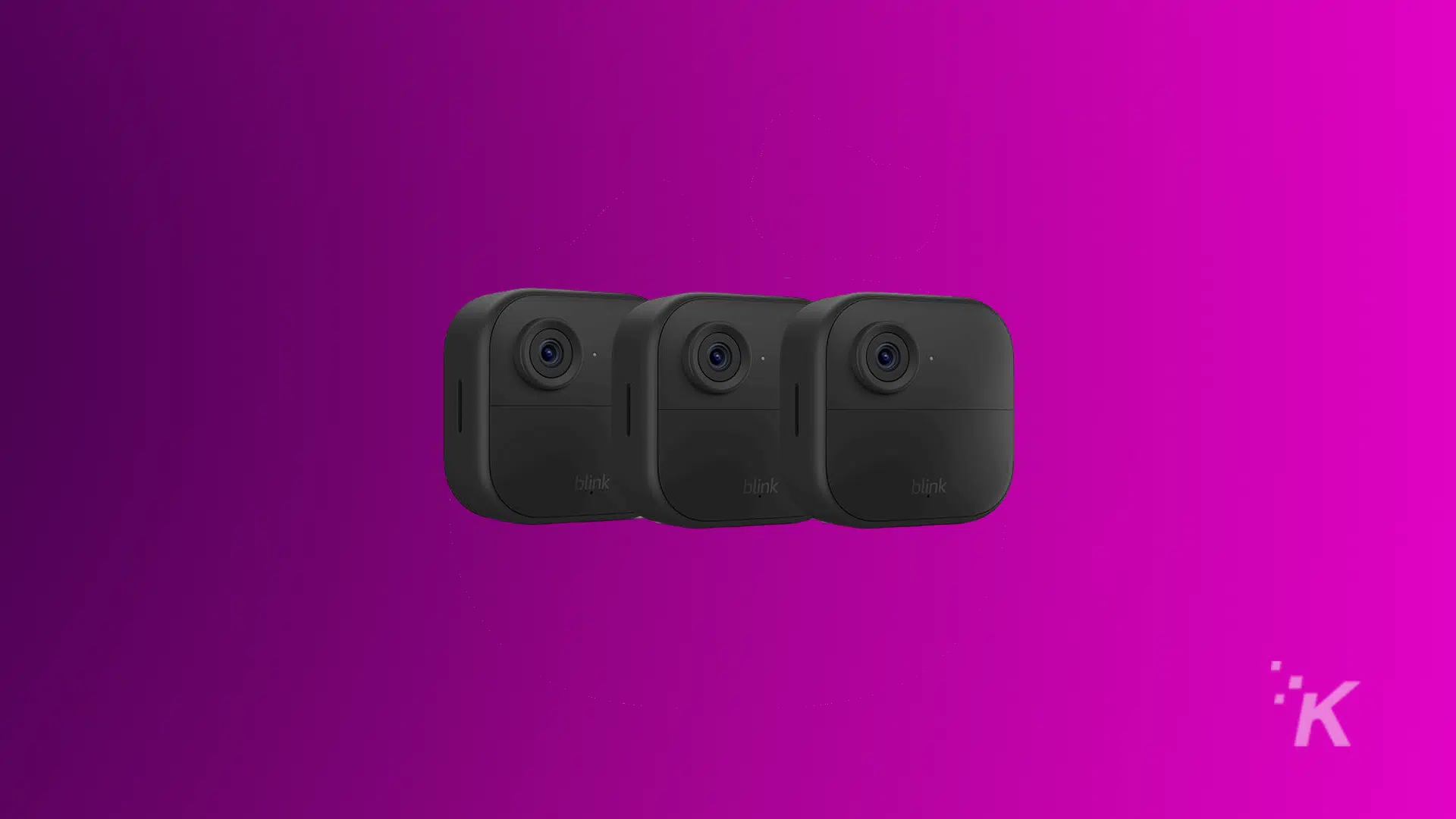 Three black Blink security cameras in a horizontal line on a purple background.