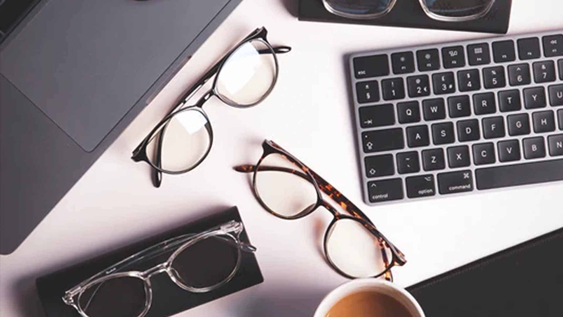 Ocushield anti blue light glasses on table with keyboard
