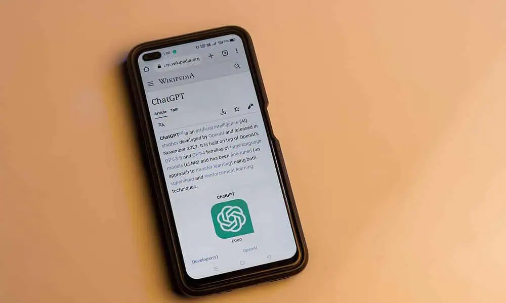 Webpage of ChatGPT, a prototype AI chatbot, is seen on the website of OpenAI, on a smartphone. Examples, capabilities, and limitations are shown.